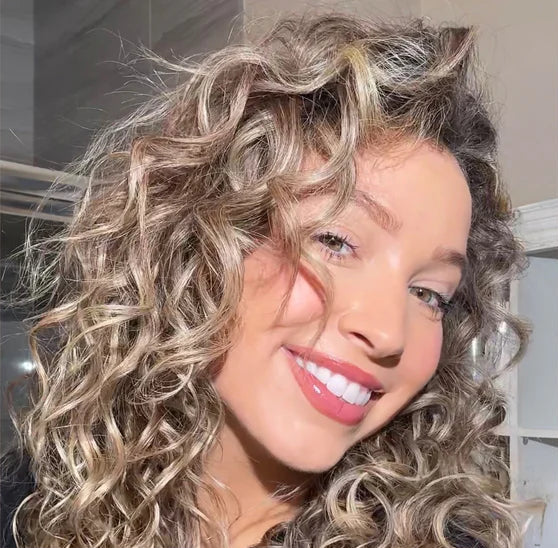 Glossy, defined curls in studio light